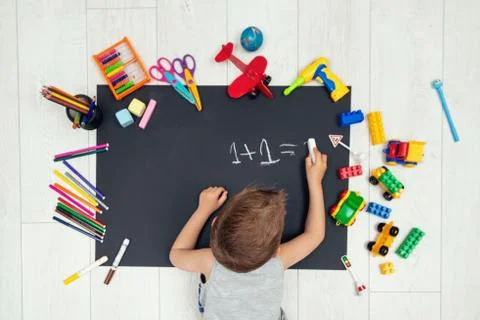 Little boy learning to write numbers. Learning math Stock Photos