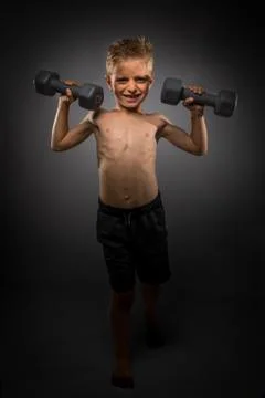 A Little Boy Lifting Weights Foto stock