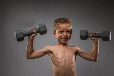 A Little Boy Lifting Weights Foto stock