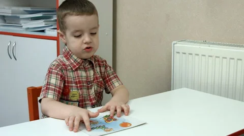 Little boy looking at and studying Stock Footage 64146907