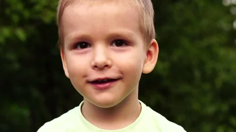 Little boy is looking at the camera. Slow motion Stock Footage 80051079