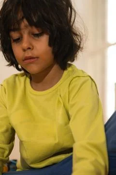 Little boy looking down feeling sad or pensive Stock Photos