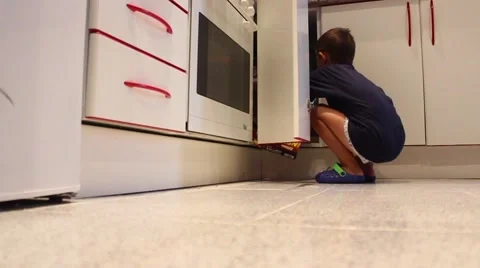 A little boy looking for something on the bedside table Stock Footage 65300344
