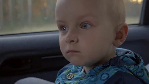 Little boy looking through window in the car, closeup face Video stock 74715107