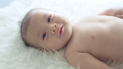 Little boy lying on bed and looking at camera Stock Footage 108646148