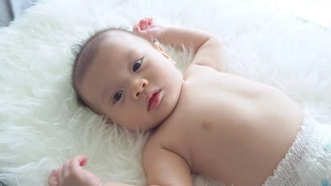 Little boy lying on bed and looking at camera Stock Footage 108646176