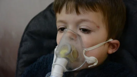 Little boy make inghalation in room with low light Video stock 123372375