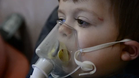 Little boy make inghalation in room with low light Stock Footage 123372404