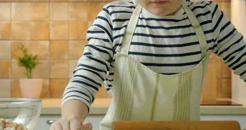 Little boy make rolling-pin dough on the kitchen Video stock 123515080