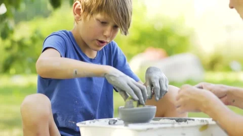 Little boy making ceramic pot on the pottery class. Child working with clay Stock Footage 157958174