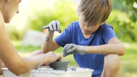 Little boy making ceramic pot on the pottery class. Child working with clay Stock Footage 158874617