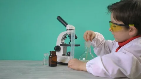 Little boy making chemical experiment with liquid Stock Footage 104976363