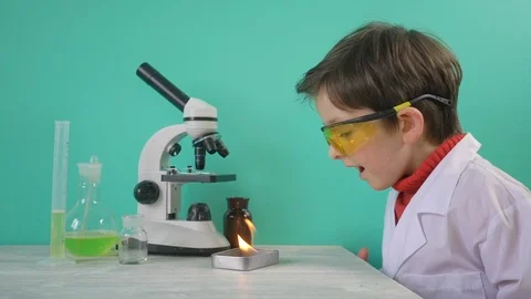 Little boy making chemical experiment with fire Stock Footage 104976395