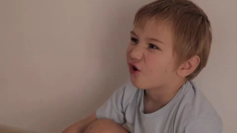 Little boy making funny faces indoors Stock Footage 323133749