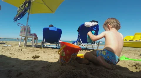 Little Boy Making a Sandcastle on the Beach on a Summer Day Video stock 61351564
