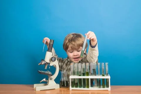 Little boy making science experiments. Research and education in school. Stock Photos
