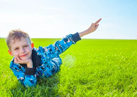 Little boy on meadow Stock Photos