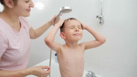 Little boy with mother taking bath and washing under shower. Concept of hygine Stock Footage 166284699