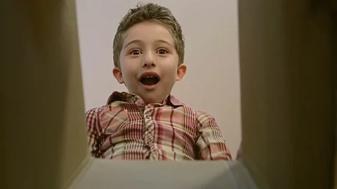 Little boy opens a parcel box with different  emotions , being surprised. Stock Footage 80162007