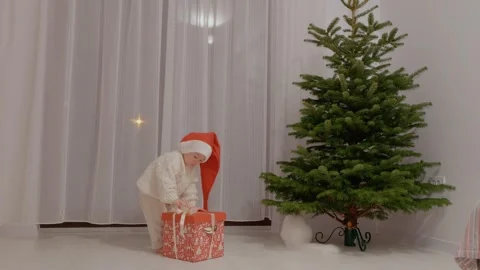 Little boy opens toy box to decorate Christmas tree Stock Footage 346697111