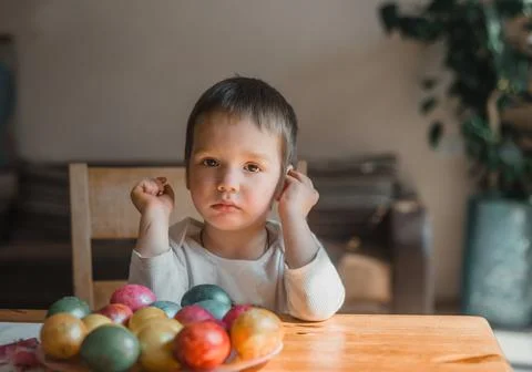 A little boy painting and decorating Easter eggs Stock Photos