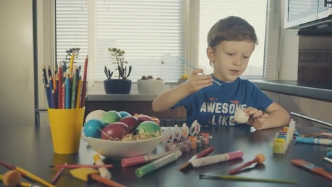 Little boy painting easter eggs Stock Footage 126283892