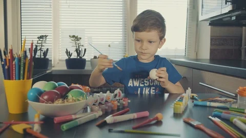 Little boy painting easter eggs Stock Footage 126283928