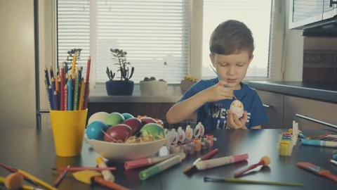 Little boy painting easter eggs Stock Footage 126283990