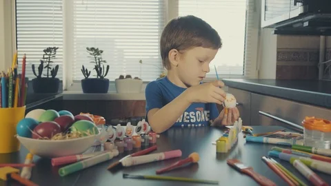 Little boy painting easter eggs Stock Footage 126283991
