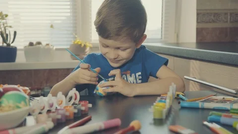 Little boy painting easter eggs Stock Footage 126284154