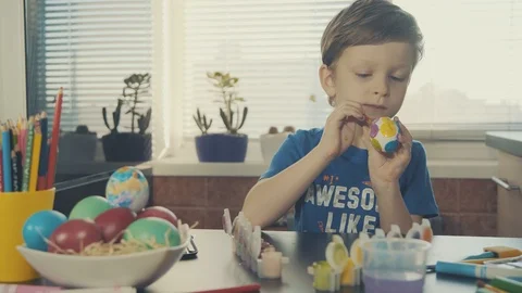 Little boy painting easter eggs Stock Footage 126284174