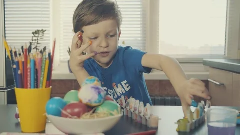 Little boy painting easter eggs Stock Footage 126284186