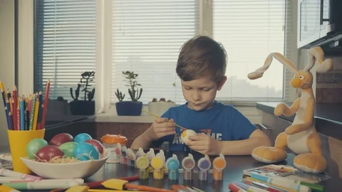 Little boy painting easter eggs Stock Footage 126284330