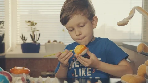 Little boy painting easter eggs Stock Footage 126284386