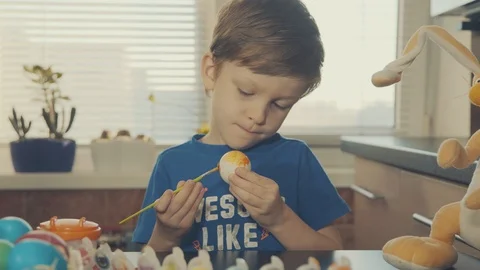Little boy painting easter eggs Stock Footage 126284391