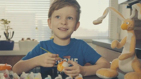 Little boy painting easter eggs Stock Footage 126284420