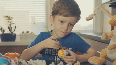 Little boy painting easter eggs Stock Footage 126284463