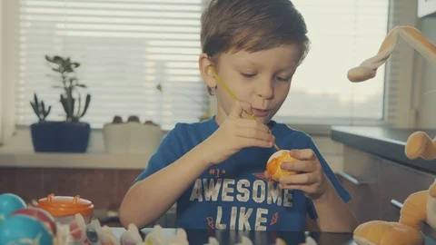 Little boy painting easter eggs Stock Footage 126284499