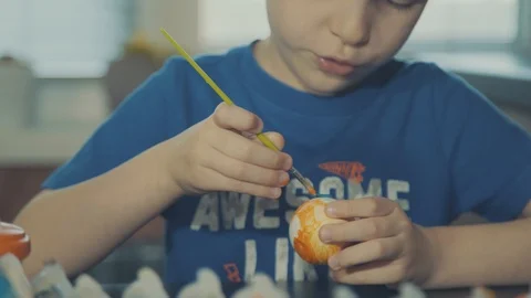 Little boy painting easter eggs Stock Footage 126284503