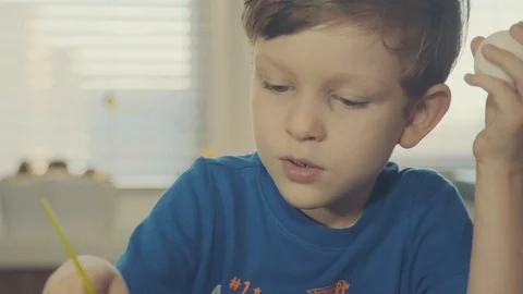 Little boy painting easter eggs Stock Footage 126284579