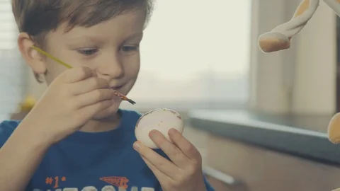 Little boy painting easter eggs Stock Footage 126284606
