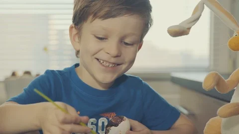 Little boy painting easter eggs Stock Footage 126284677