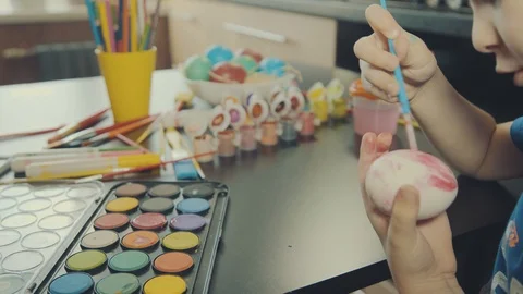 Little boy painting easter eggs Stock Footage 126333384