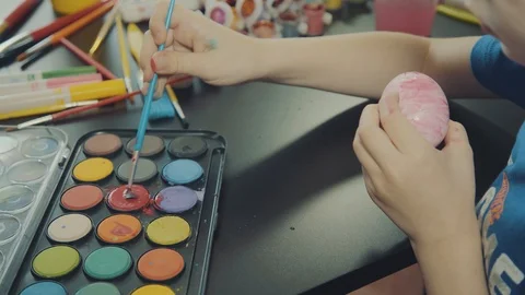 Little boy painting easter eggs Stock Footage 126334697