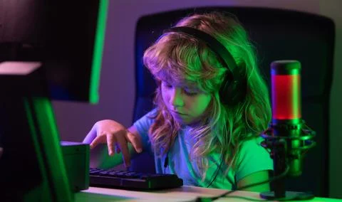 Little boy at the pc computer screen. Cute preschool kid is watching movie by Stock Photos