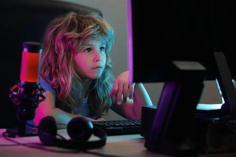 Little boy at the pc computer screen. Cute preschool kid is watching movie by Stock Photos