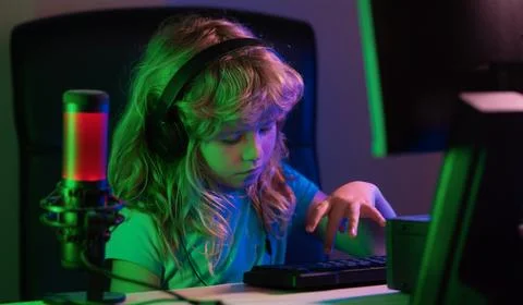 Little boy at the pc computer screen. Cute preschool kid is watching movie by Stock Photos