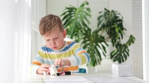 Little boy performing or studying science with wires, connections. Stock Footage 187471771