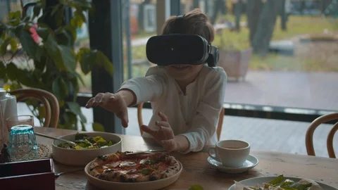 Little boy play with virtual reality glasses in cafe Stock Footage 120735205