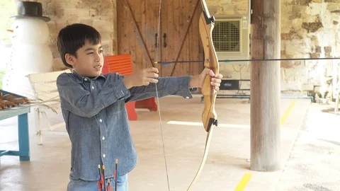 Little boy playing Archery to release the arrow Stockbeeldmateriaal 106052184